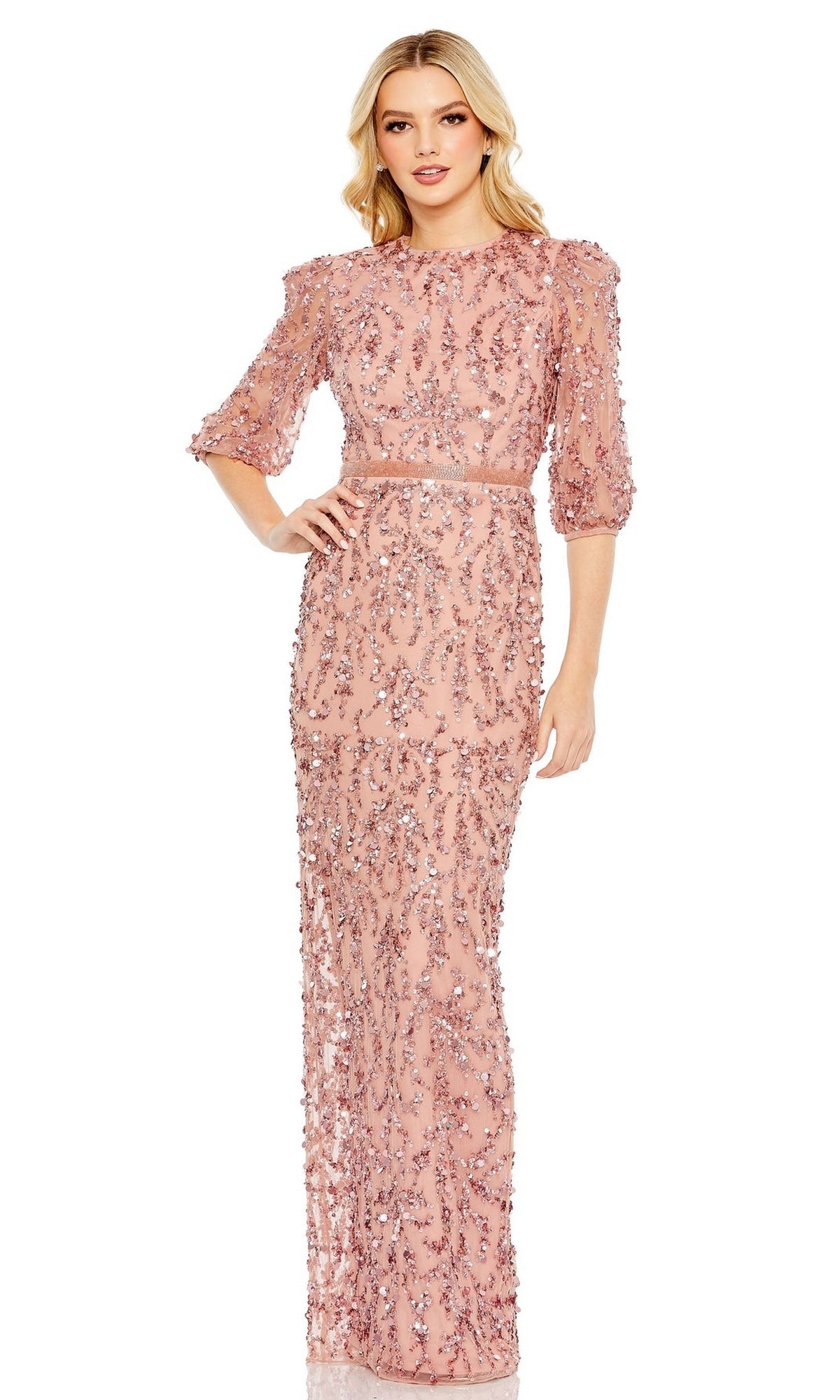 A woman stands facing forward in the Mac Duggal 93790, a floor-length formal dress featuring long sleeves and intricate beadwork.